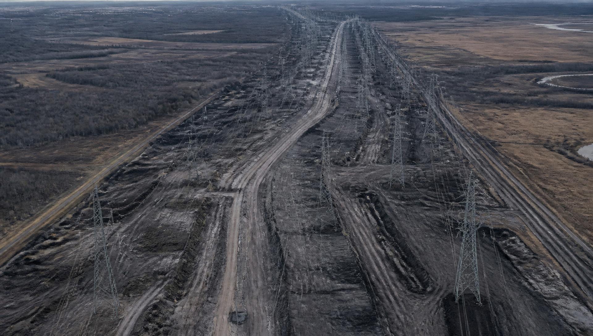 Industrial utility corridor with transmission lines and graded land